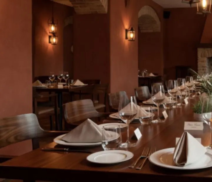 Corporate dinner setup with long tables and elegant place settings